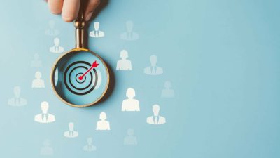 HRM or Human Resource Management, Magnifier glass focus to manager business icon which is among staff icons for human development recruitment leadership and customer target group concept.